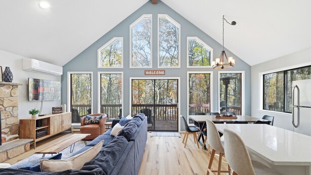 A modern interior with a large living area, a dining space, and a kitchen. - Peaceful fully renovated chalet in Lake Harmony, dog friendly! (Lake Harmony)