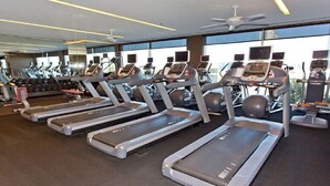A gym with treadmills, exercise bikes, and a large mirror. - Not Available  51-303 floor (Las Vegas)