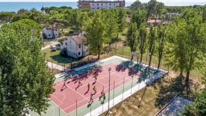 An aerial view of a residential area with a basketball court surrounded by trees and houses. - Nice home in Cavallino-Treporti (Cavallino-Treporti)