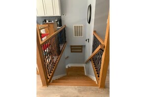 Staircase leads to an upper floor with a door at the bottom.