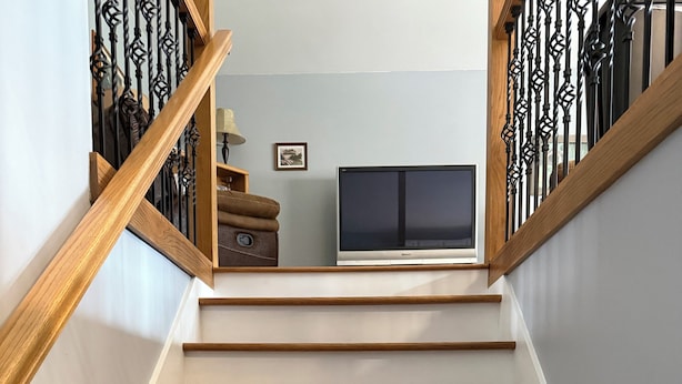 A staircase with wooden steps and black metal railings. - Peaceful Country Home w/Covered Bridge (Athens)