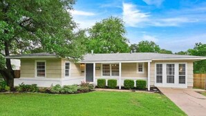 A single-story house with a covered porch, a front yard, and a backyard.