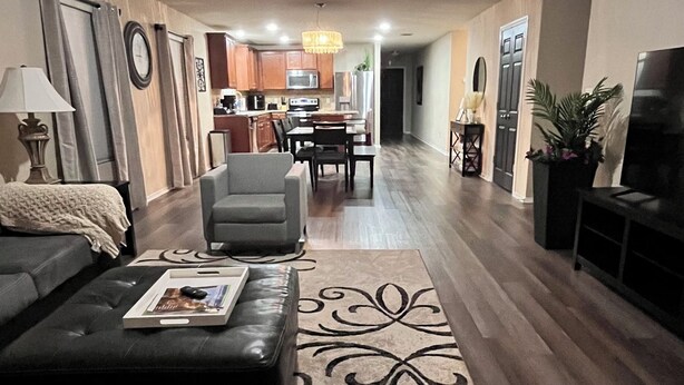 A living room with a sofa, a coffee table, a rug, and a TV. - A Family Cozy Getaway 7 miles from Sea World and Fiesta, Texas (San Antonio)