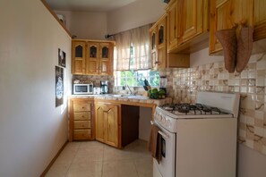 Studio | Private kitchen | Full-sized fridge, microwave, oven, stovetop - Eleven30 Luxury Apartments  (Negril)