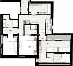 A hotel floor plan with multiple rooms, including a large bedroom, a bathroom, and a dining area.