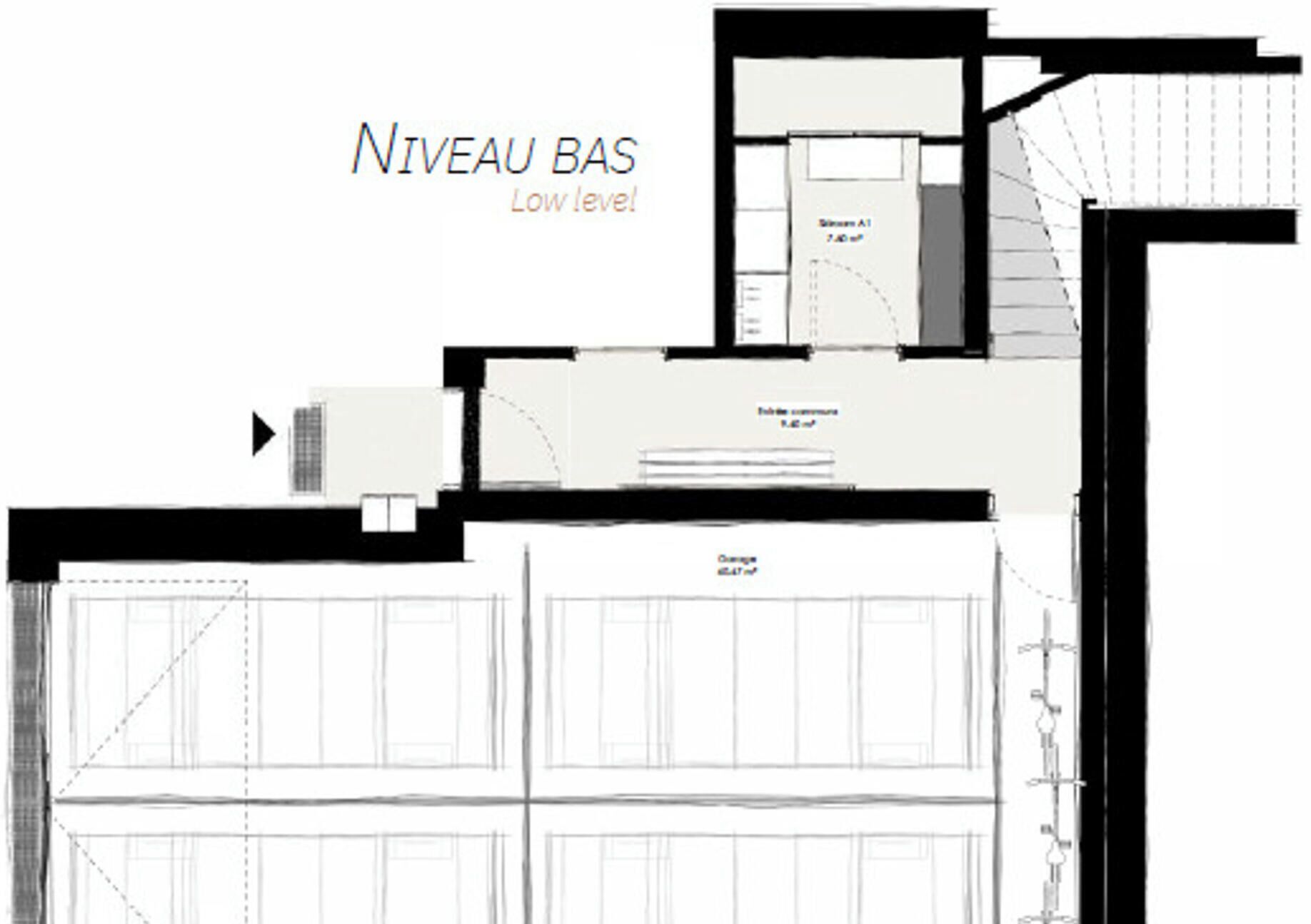 A floor plan of a building with a low-level entrance, a staircase, and a garage area.