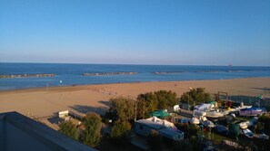 On the beach, sun-loungers - NEREIDS: PANORAMIC VIEW of SEA and BEACH from the 5th floor.  (Lido Adriano)