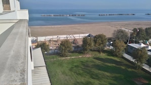 Vista costera con playa, muelle y parque infantil.