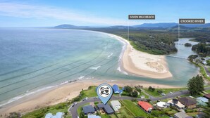 An aerial view of Seven Mile Beach and Crooked River, with houses and a bridge nearby. - Prime Position -  Family Getaway (Gerroa)