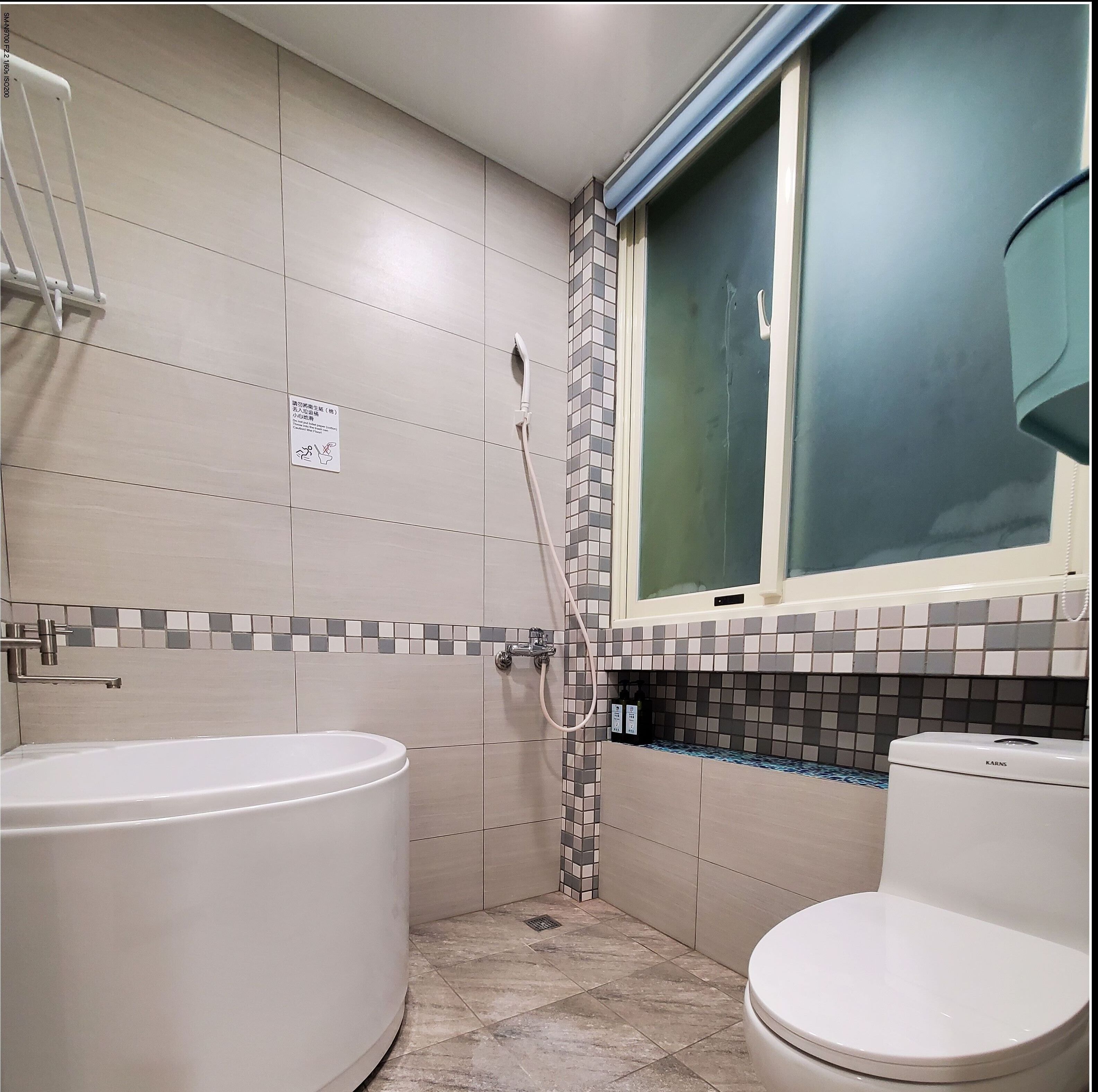 A bathroom with a bathtub, toilet, and shower.