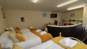 A hotel room with two beds, a sitting area, a kitchen, and a TV. - Annex St Ann's (Rotherham)