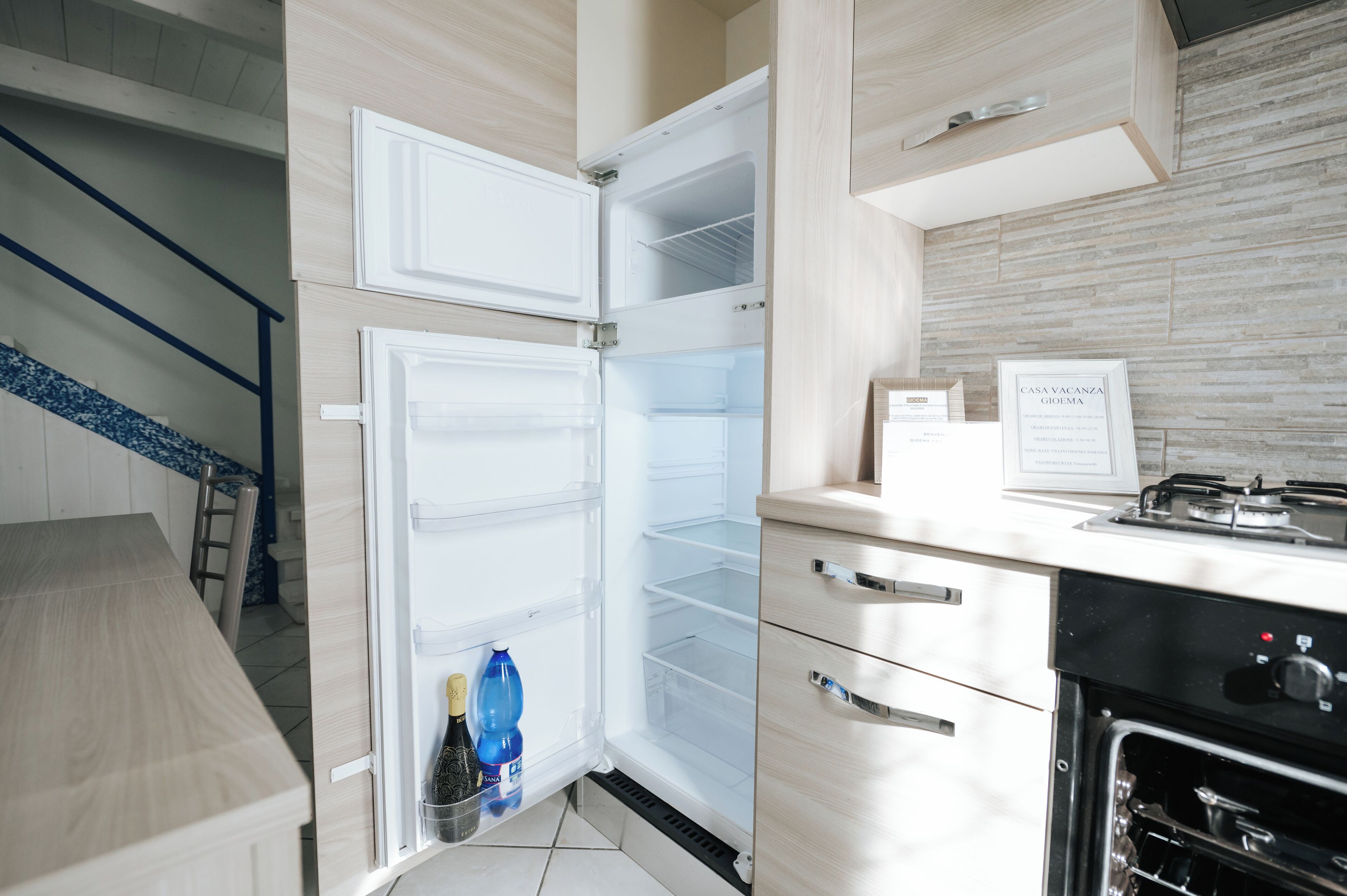 A modern kitchen with a built-in refrigerator, oven, and a gas stove.