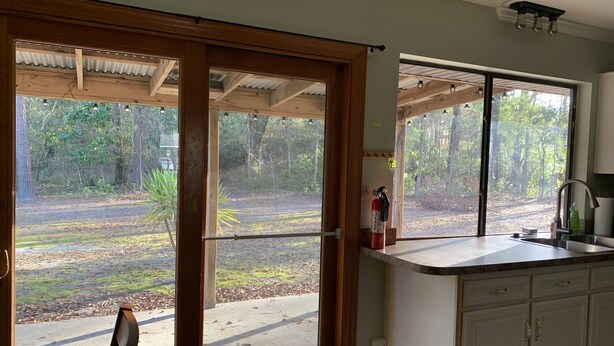 A kitchen with a large window, a fire extinguisher, and a sink. - Quality comfort in a convenient location (entire house) (Beaufort)