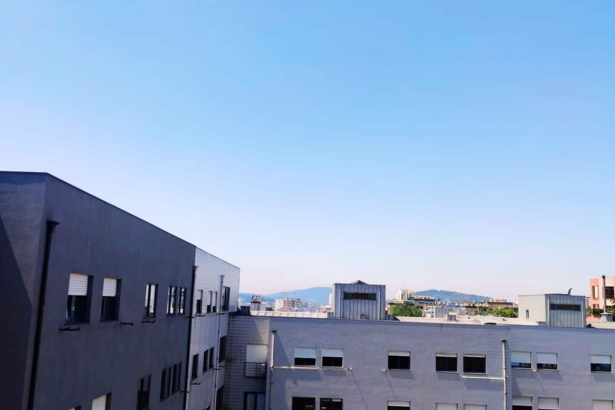 A modern building with multiple floors and a flat roof.
