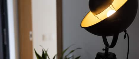 A lamp with a spherical shade on a tripod stand.