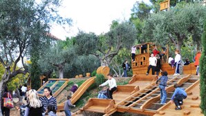 A playground with wooden slides and climbing structures.