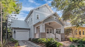 A two-story house with a front porch, garage, and a well-maintained garden. - Great summer deals! Golf cart & bikes included! Steps to pool, close to beach (Santa Rosa Beach)