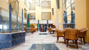 A spacious lobby with a fountain, wicker chairs, and a glass coffee table. - Mix Peymar (Sant Llorenc des Cardassar)