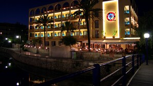 A multi-story hotel with balconies, a pool area, and a waterfront view. - Mix Peymar (Sant Llorenc des Cardassar)