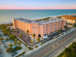 A multi-story hotel with a rooftop pool, located near a beach with a view of the ocean. - Beachfront w/ Views! Kid & Pet-friendly, Heated Pool, Spa, Pickle Ball/Tennis (Indian Rocks Beach)