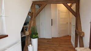 A hallway with wooden beams, white walls, and a radiator. - Exclusive, high-end ***** vacation rental with a large garden (Freiamt)
