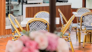 A restaurant interior with a bar area, seating arrangement, and a view of the street outside. - CASA HIDALGO ECUADOR (Cumbayá)