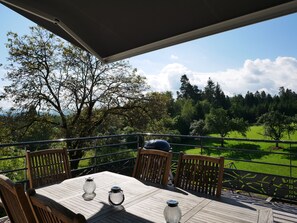 Relax on the patio surrounded by lush greenery and enjoy the serene views.