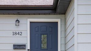 A dark blue front door with a small window, a mailbox, and a number '1842' on the wall. - The Robberson House close to Mercy, WOW, MSU (Springfield)