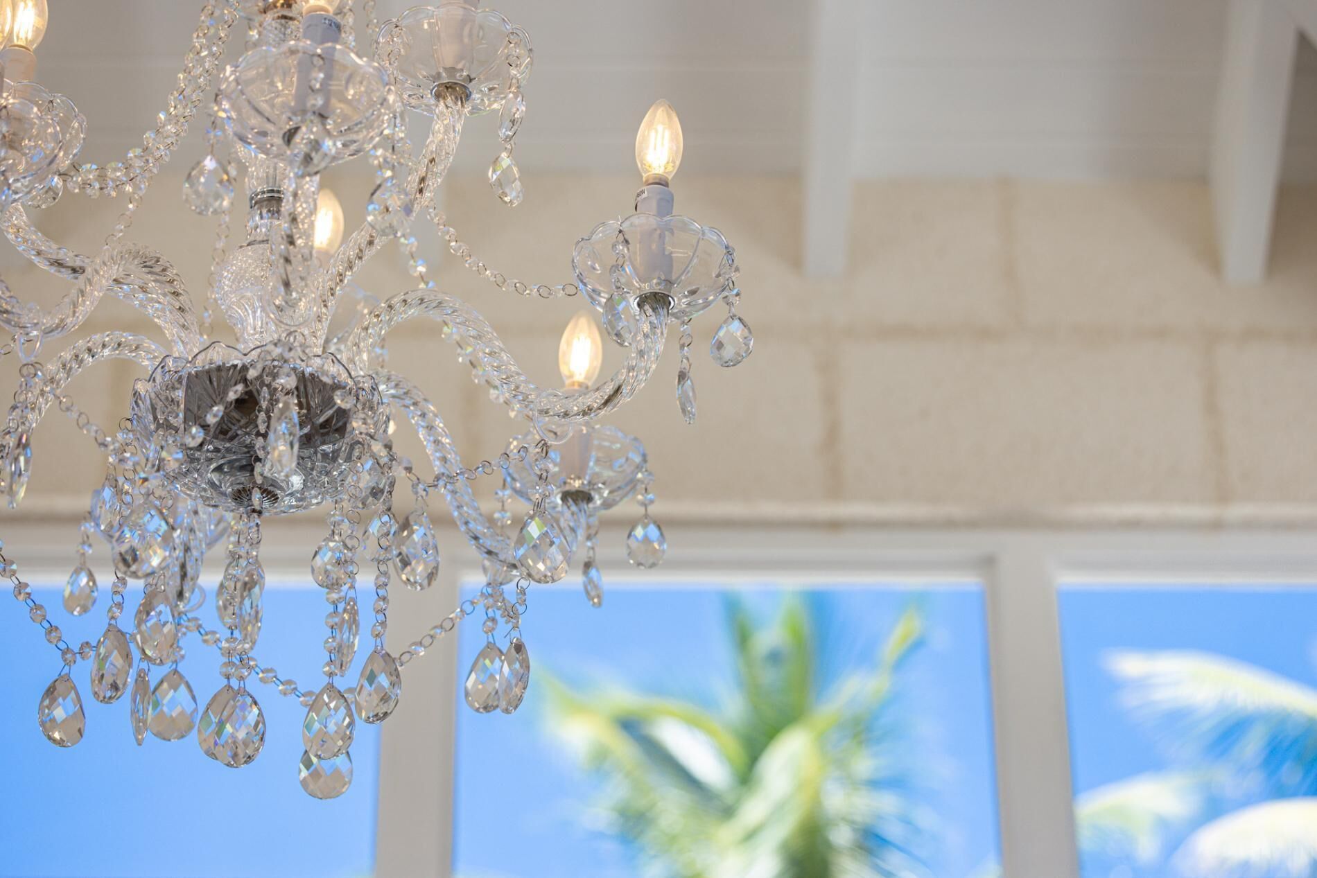 A chandelier with multiple light bulbs and crystal decorations.
