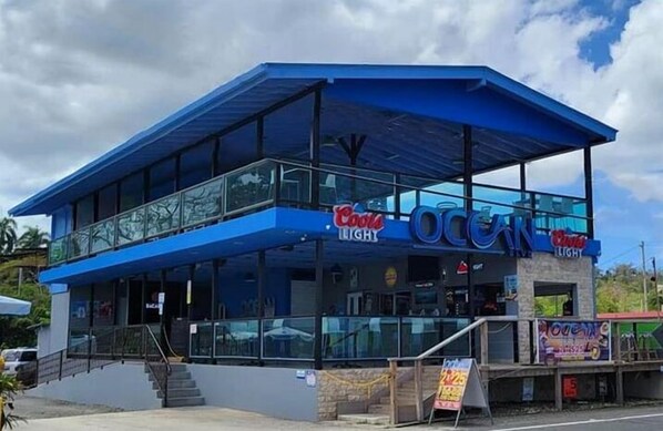 A two-story building with a blue exterior and a sign that reads "Ocean Light."