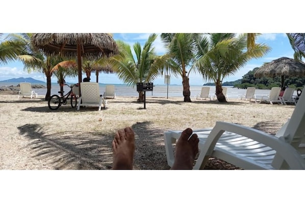 On the beach, sun-loungers