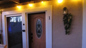 A building entrance with a wooden door, a large window, and a wall-mounted light fixture. - BEARADISE 1 - Five Min Walk To Downtown Banner Elk (Banner Elk)