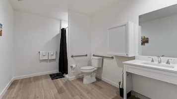 A modern bathroom with a toilet, bidet, and sink.