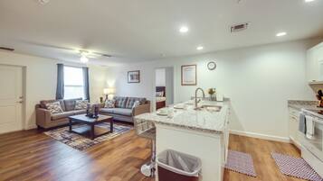 A modern apartment with a living room, kitchen, and dining area.