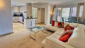 A modern apartment with a kitchen, dining area, and living room. - Central Two Bedroom Apartment on the Second Line of the Beach in Marbella. (Marbella)