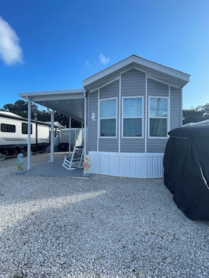 Guests can enjoy a covered porch area with stairs leading to the entrance.