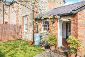 Welcome to this charming cottage with a cozy front porch and garden.