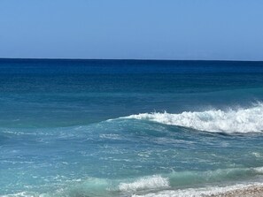 A clear view of the ocean with waves approaching the shore.