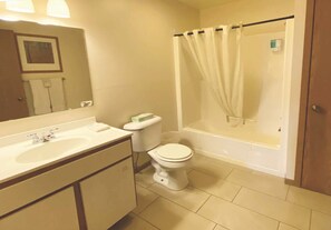 A bathroom with a sink, toilet, and bathtub.