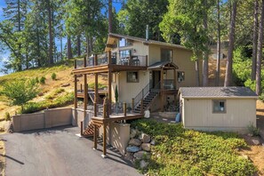 A two-story cabin with a deck, stairs, and a small shed. - Hot Tub + Scenic Views: Luxury Twain Harte Cabin! (Twain Harte)