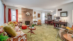 A cozy living room with a sofa, a coffee table, and a fireplace.