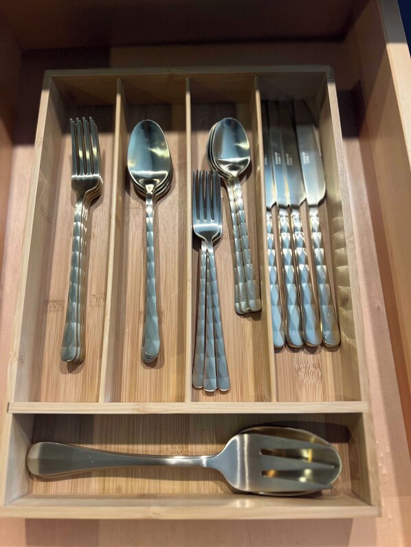 A drawer containing various silverware including forks, spoons, knives, and a spatula. - Modern Lakefront house, steps away from water's edge and Island Lake fishing (Duluth)