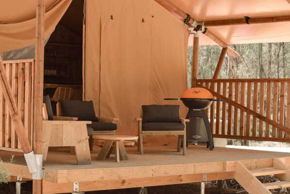 A wooden deck with a grill, two chairs, and a table. - Koondrook Retreat (Koondrook)