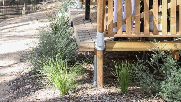 A wooden deck with a covered seating area, surrounded by natural vegetation and trees. - Koondrook Retreat (Koondrook)
