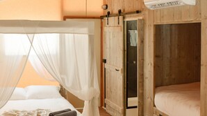 A room with a wooden floor, a bed with a canopy, a wardrobe, and an air conditioning unit. - Koondrook Retreat (Koondrook)