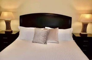 Restful retreat with a large bed, two bedside tables, and ambient lighting.