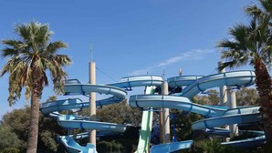A water park with multiple slides and a swimming pool. - Mobilehome with air conditioning, terrace and pool (Carovigno)