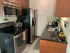 Enjoy cooking in this well-equipped kitchen with a stove, oven, microwave, and refrigerator.