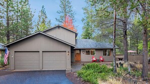 A two-story house with a garage and a covered porch. - 5 Wickiup - Hot Tub, Updated, Ping Pong, SHARC Passes, Bikes (Sunriver)