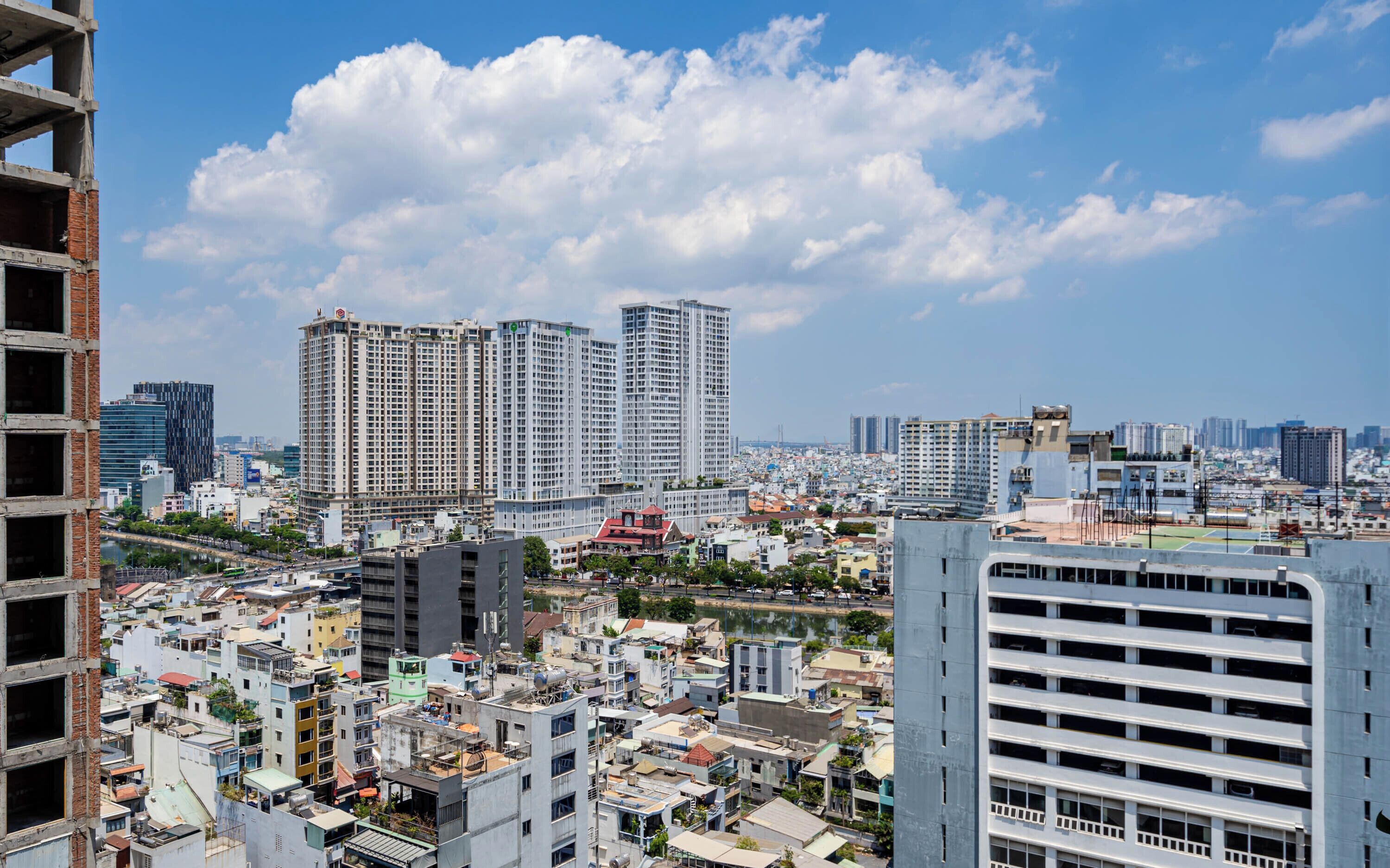 A cityscape with high-rise buildings, a river, and a mix of residential and commercial structures.